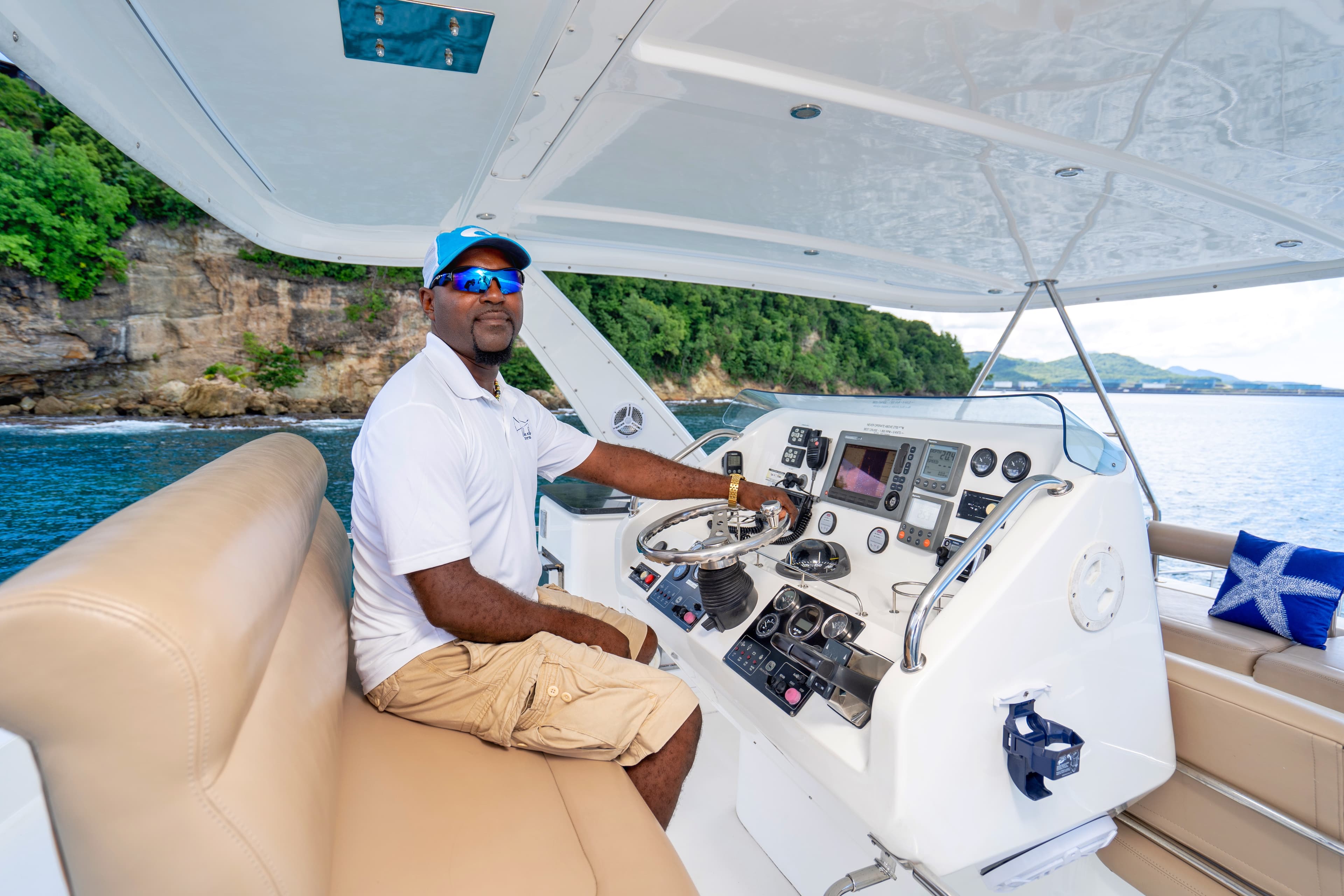 Hackshaw's crew member at the helm of a charter boat